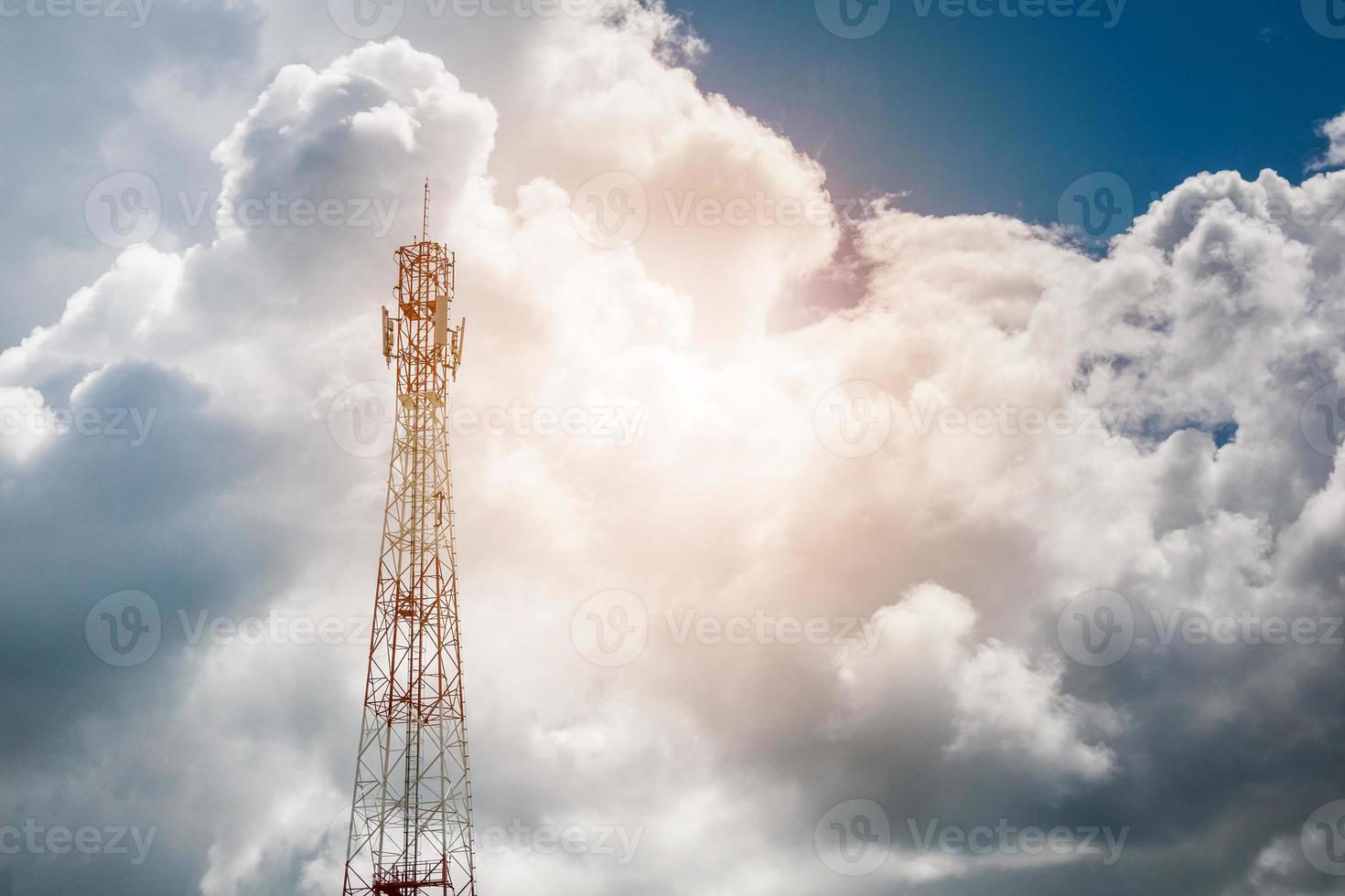 Mobile phone telecommunication tower with white cloud and blue sky mountain background photo