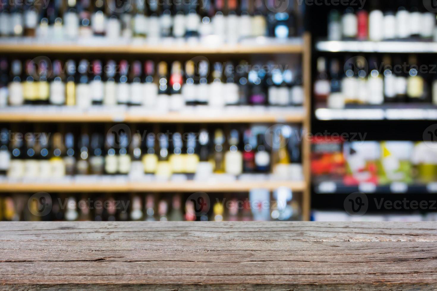 Abstract blur wine bottles on liquor alcohol shelves in supermarket background photo