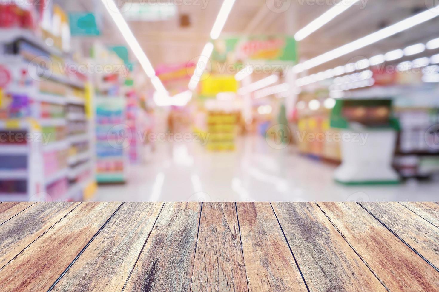 Supermarket store abstract blur background with wood table photo
