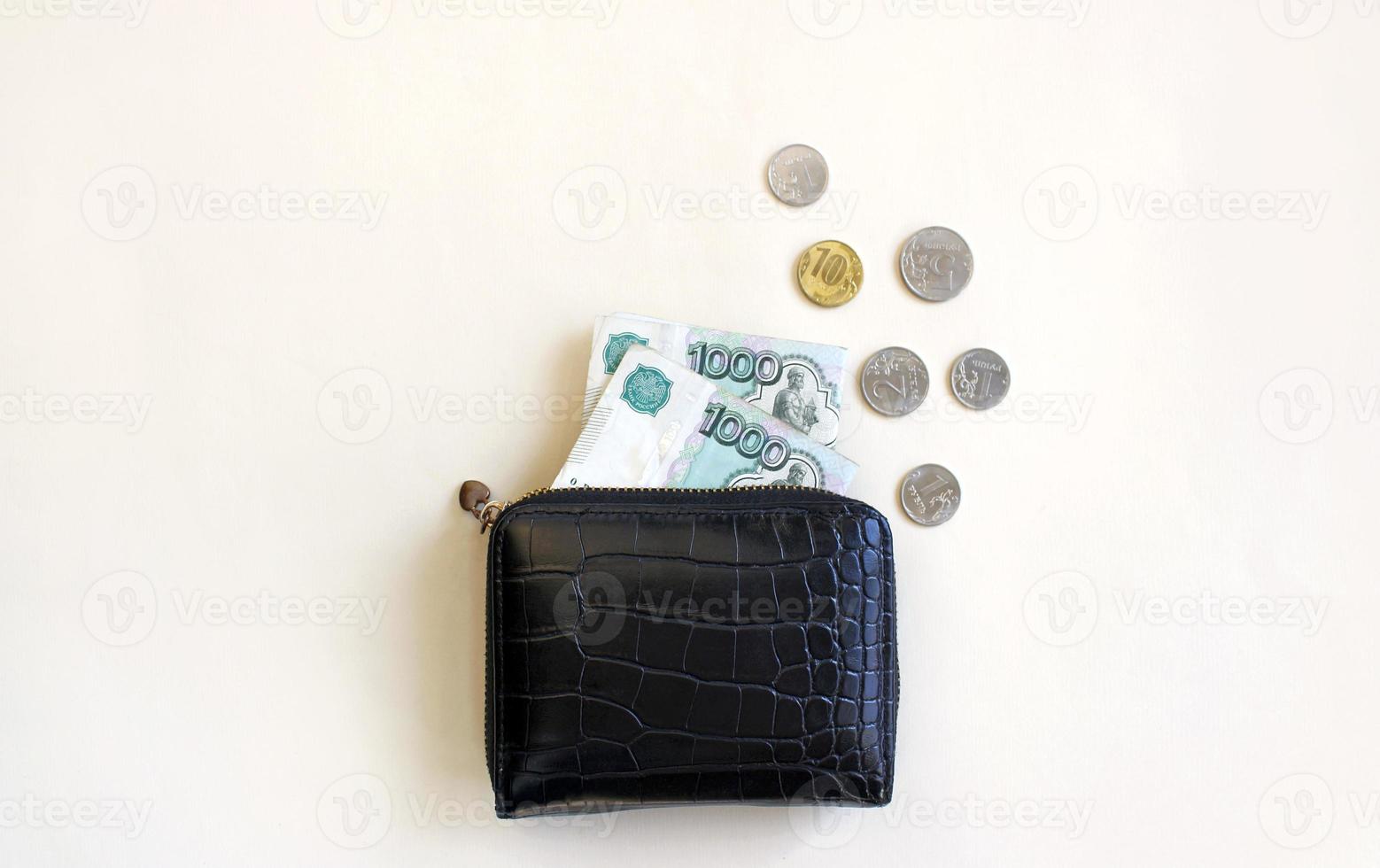 Russian rubles in the wallet on background. Thousand notes and various coins. Place for text. Copy space. background for economic news. selective focus photo