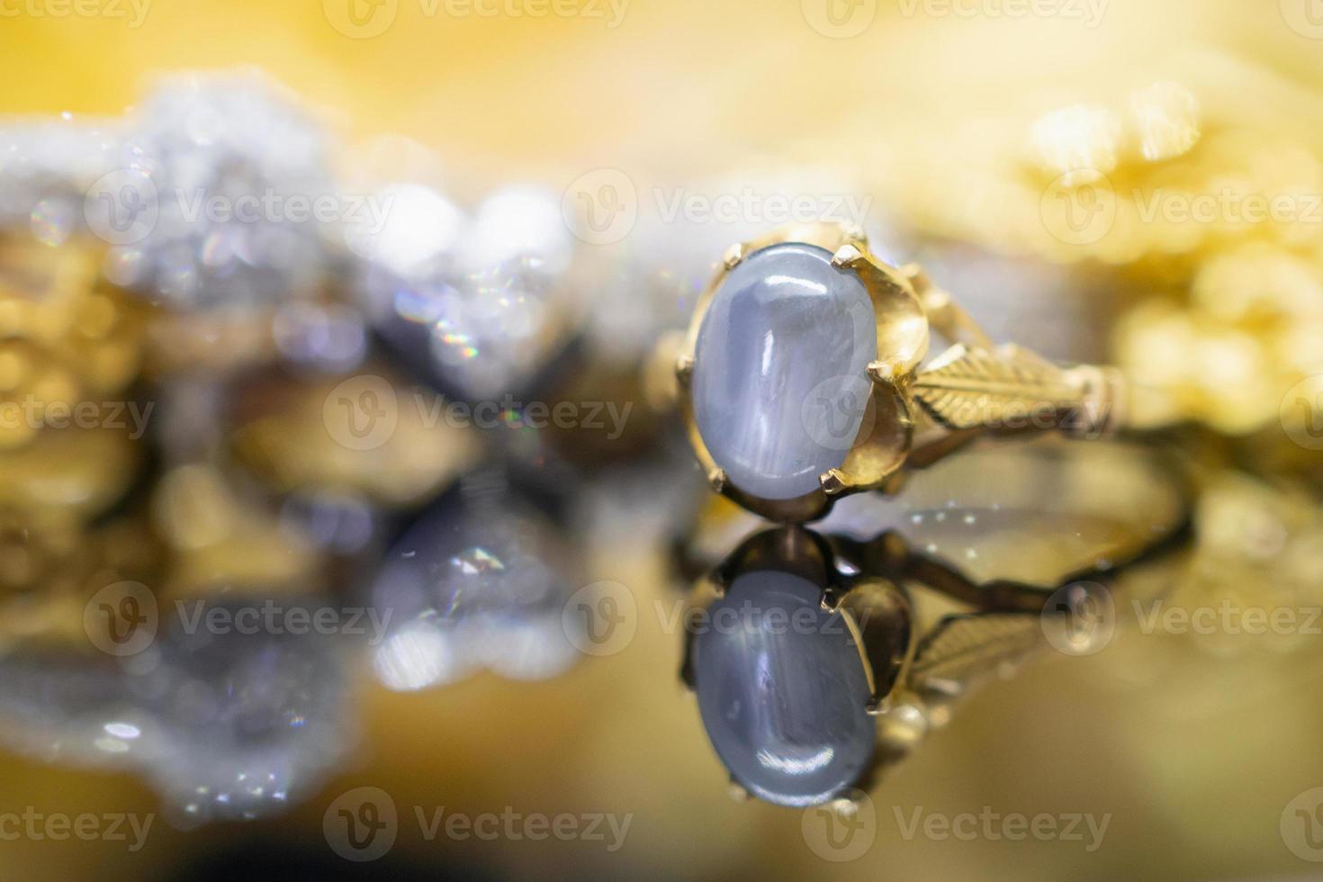 Vintage gold Jewelry blue sapphire rings with reflection on black background photo