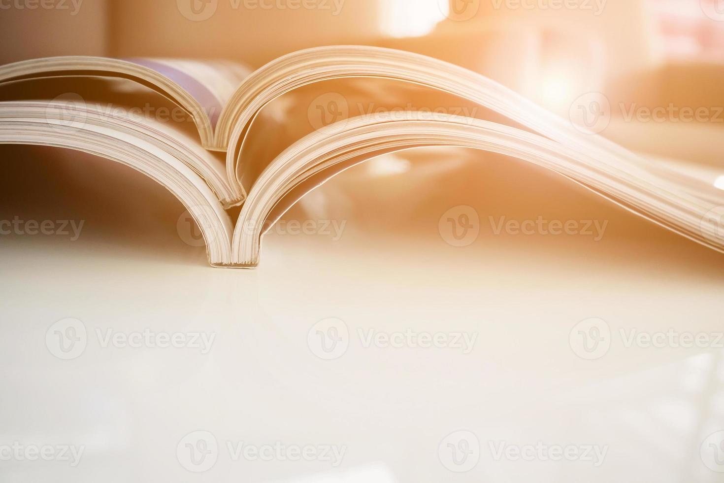 pile of magazines stack on white table in living room photo