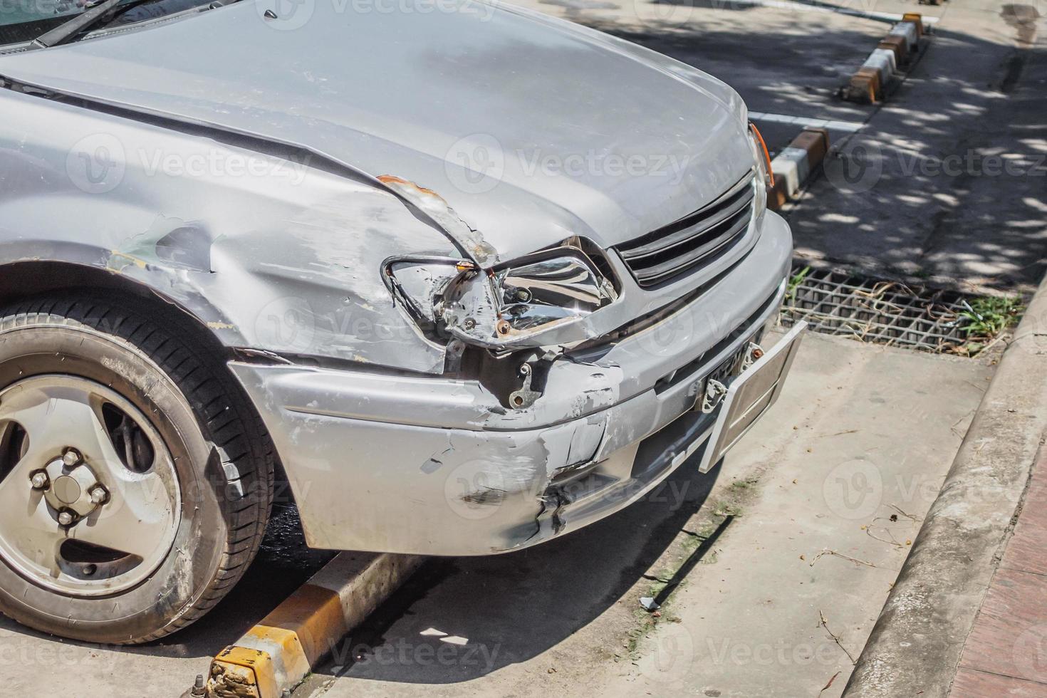 car damaged on the front cause by car crash accident on the road photo