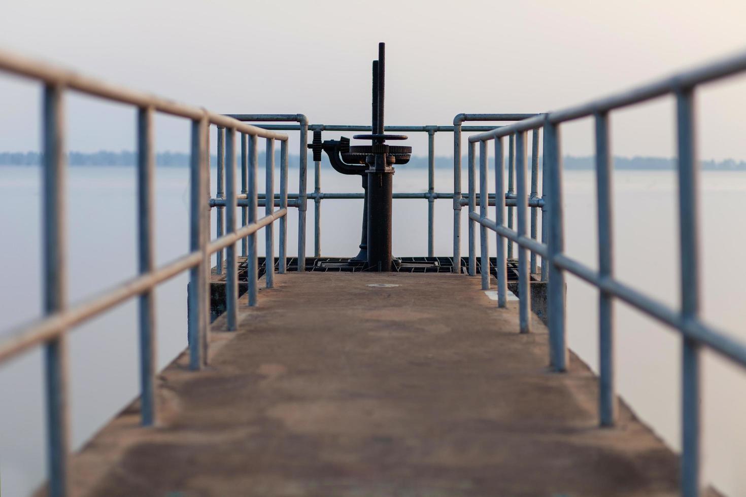 The walkway opens and closes the dam's water gate. photo