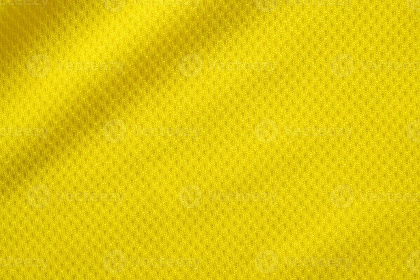 Yellow color football jersey clothing fabric texture sports wear background, close up photo