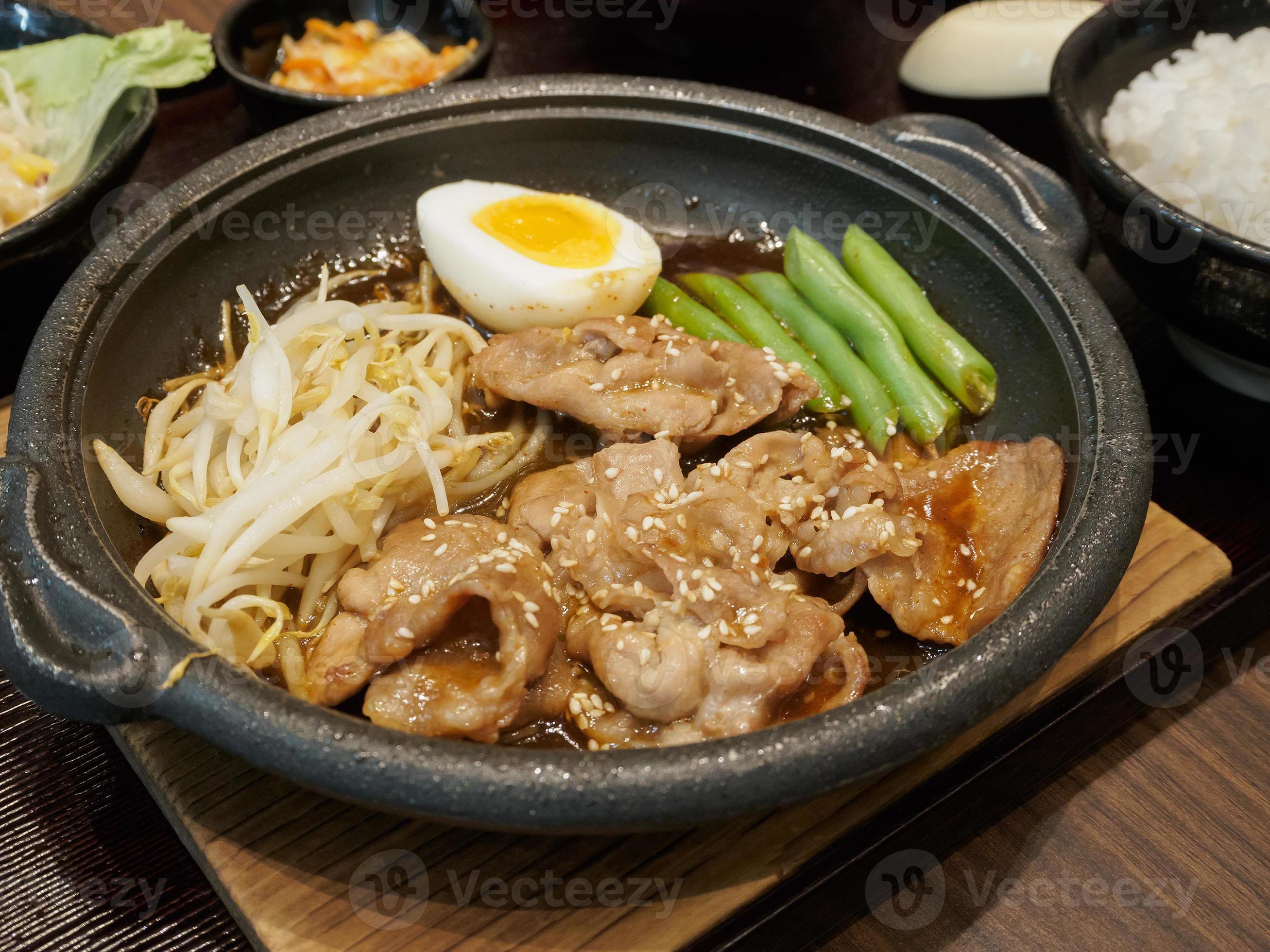 pork teppanyaki with egg and vegetables in hot plate Japanese Cooking