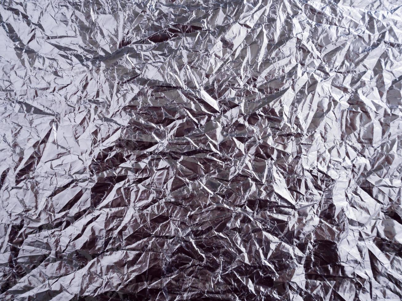 Silver foil with shiny crumpled surface photo