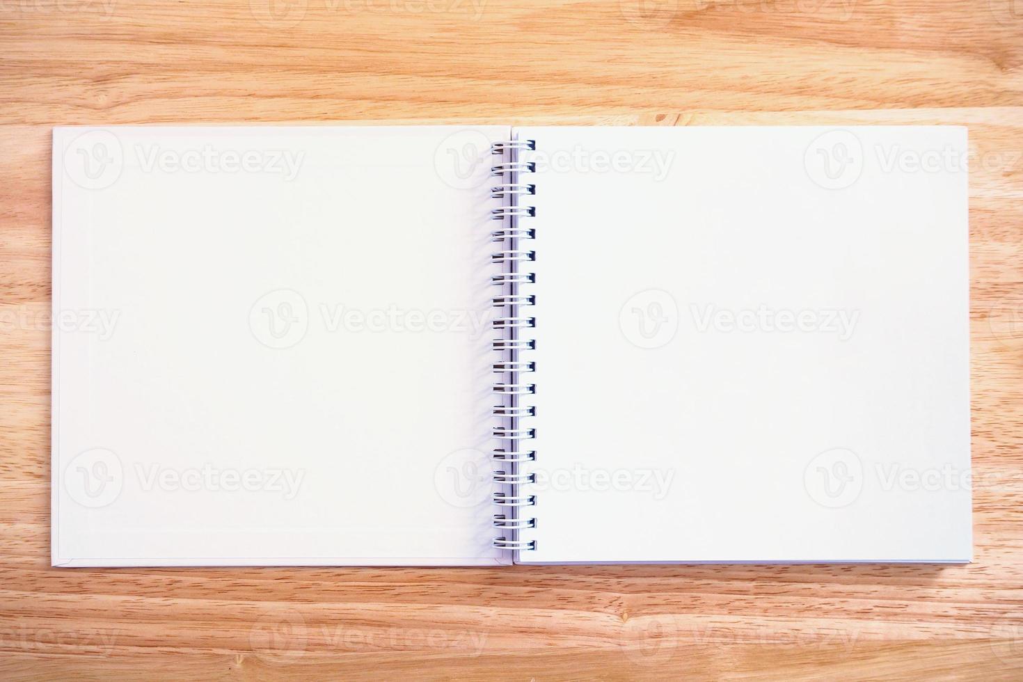 open notebook on wood table background photo