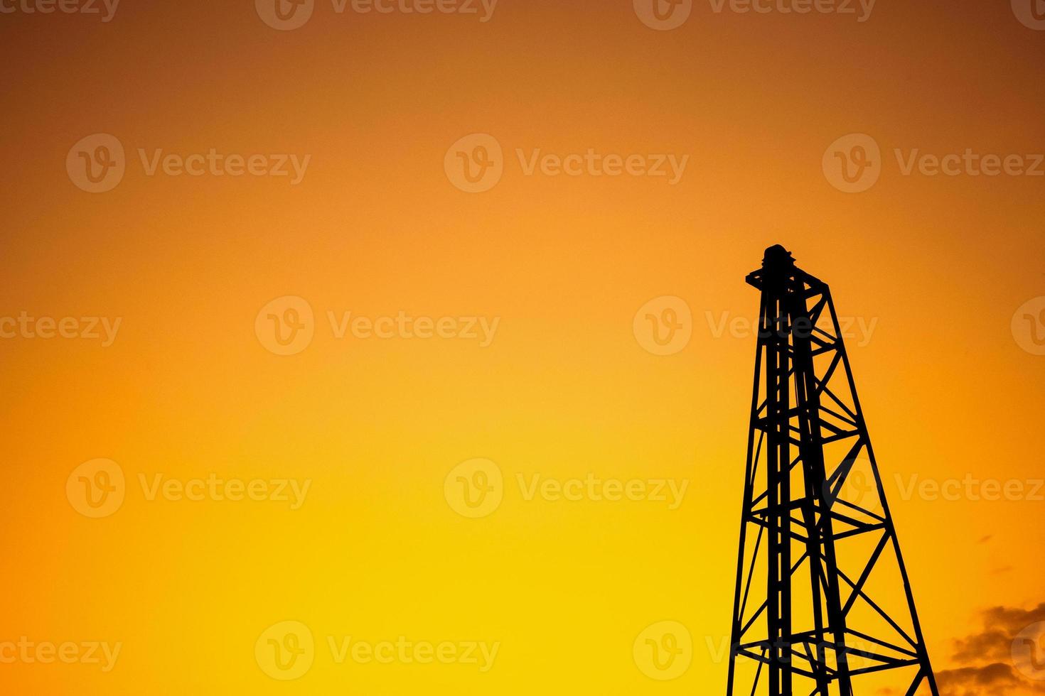 Silhouette pile driver at construction site photo