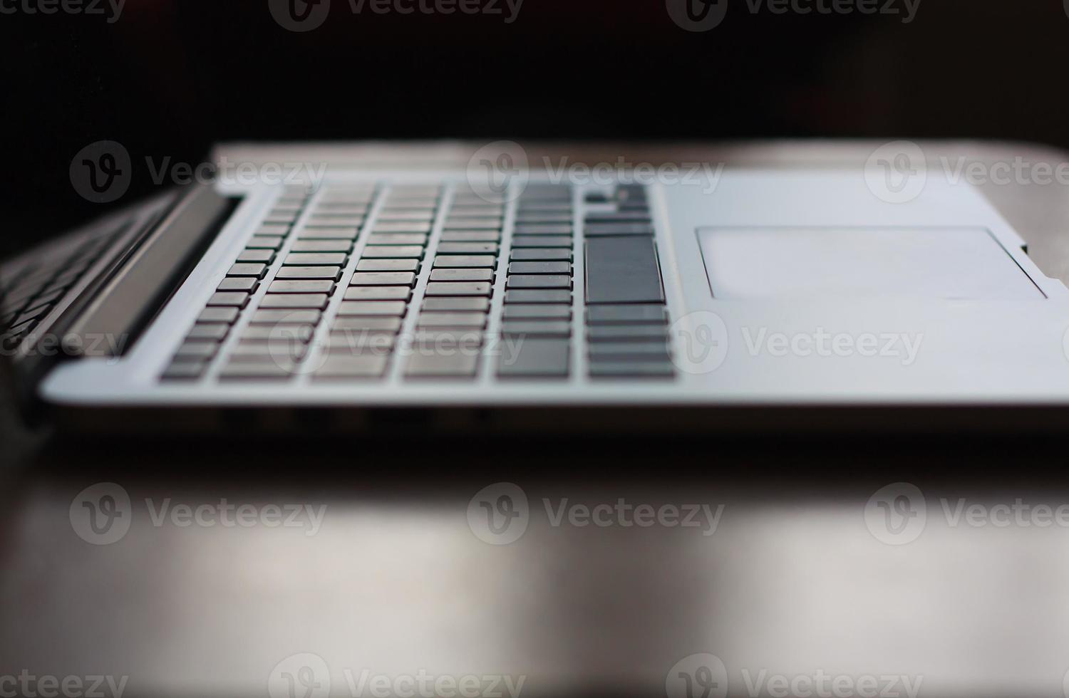 open laptop with black screen on modern wooden desk photo