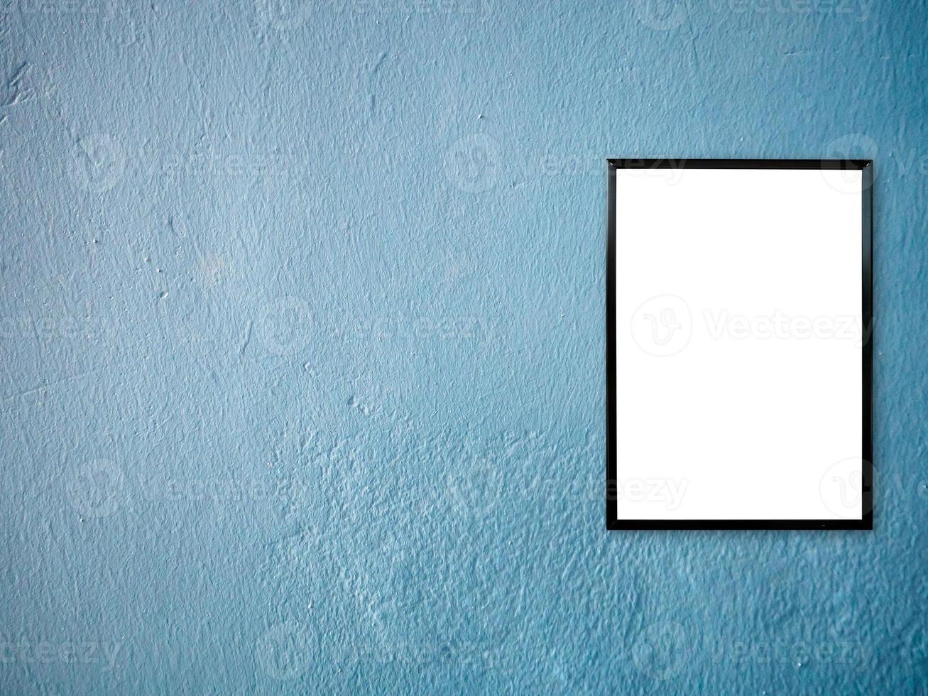 poster frame on blue paint wall background photo