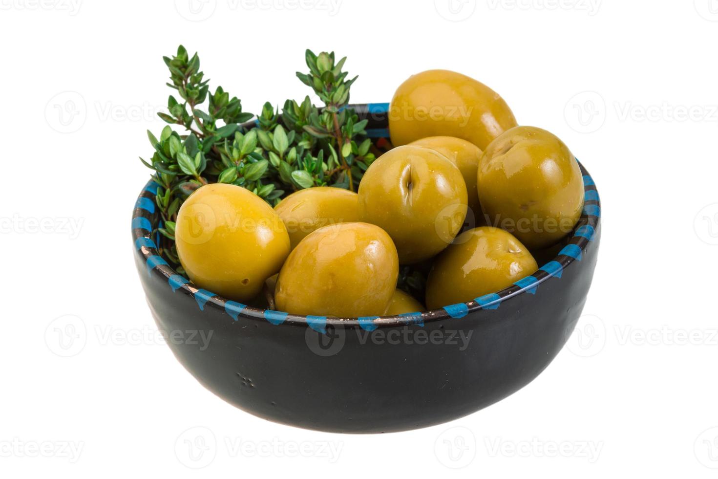 Gigant olives in a bowl on white background photo