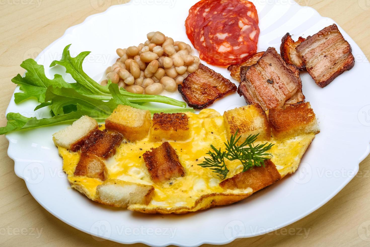 Breakfast with eggs, bacon and beans photo