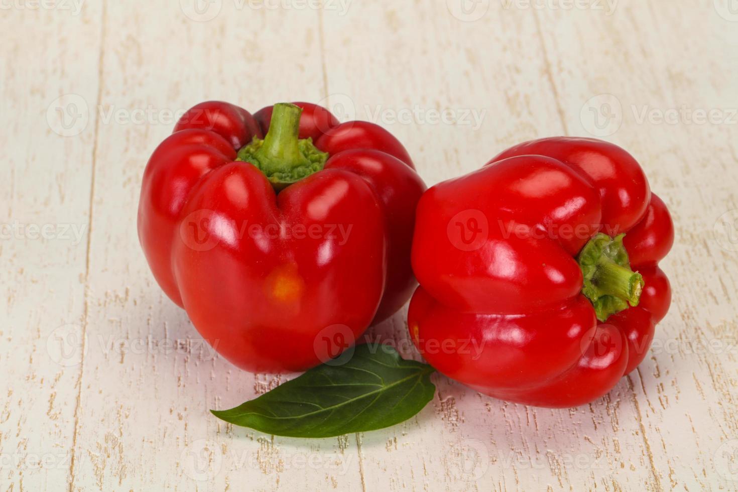 Ripe Red bell pepper over wooden photo