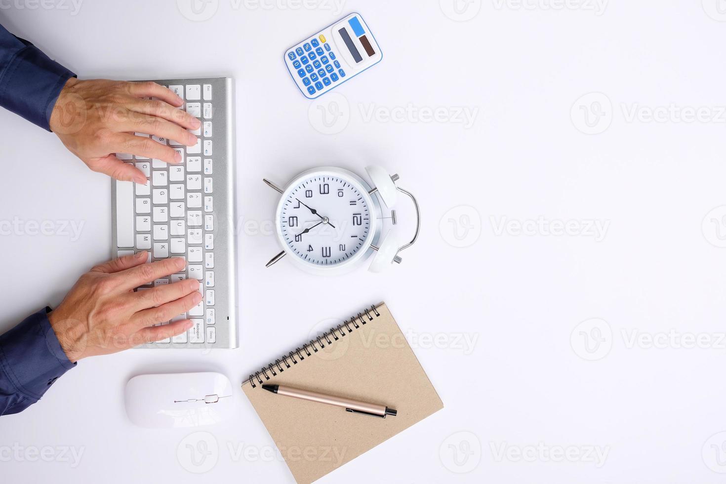 Office desk with smartphone, laptop computer, cup of coffee, and office tools. Flat lay, top view with copy space. A bank notepad and a pen are on top of an office desk table containing computer tools photo