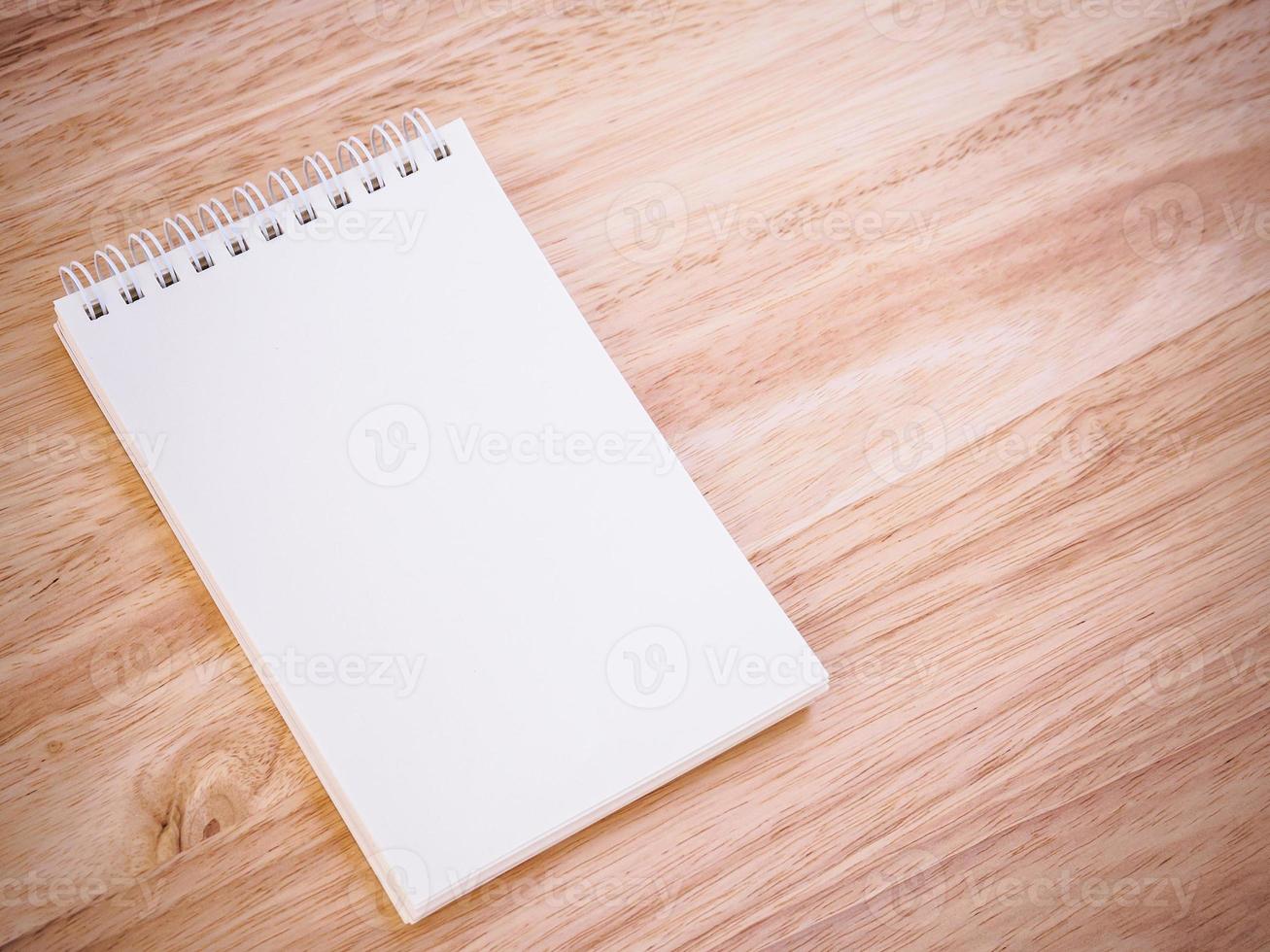 Notepad on the wooden desk table photo