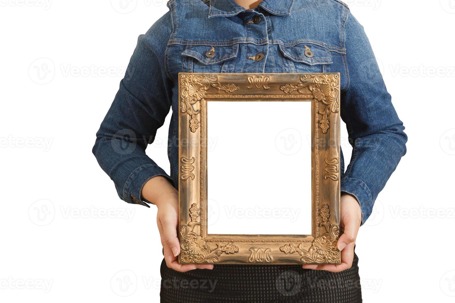 A blank diploma or a mockup certificate in the hand of a woman employee wearing a denim shirt on white background with a clipping path. The vertical picture frame is empty and the copy space. photo