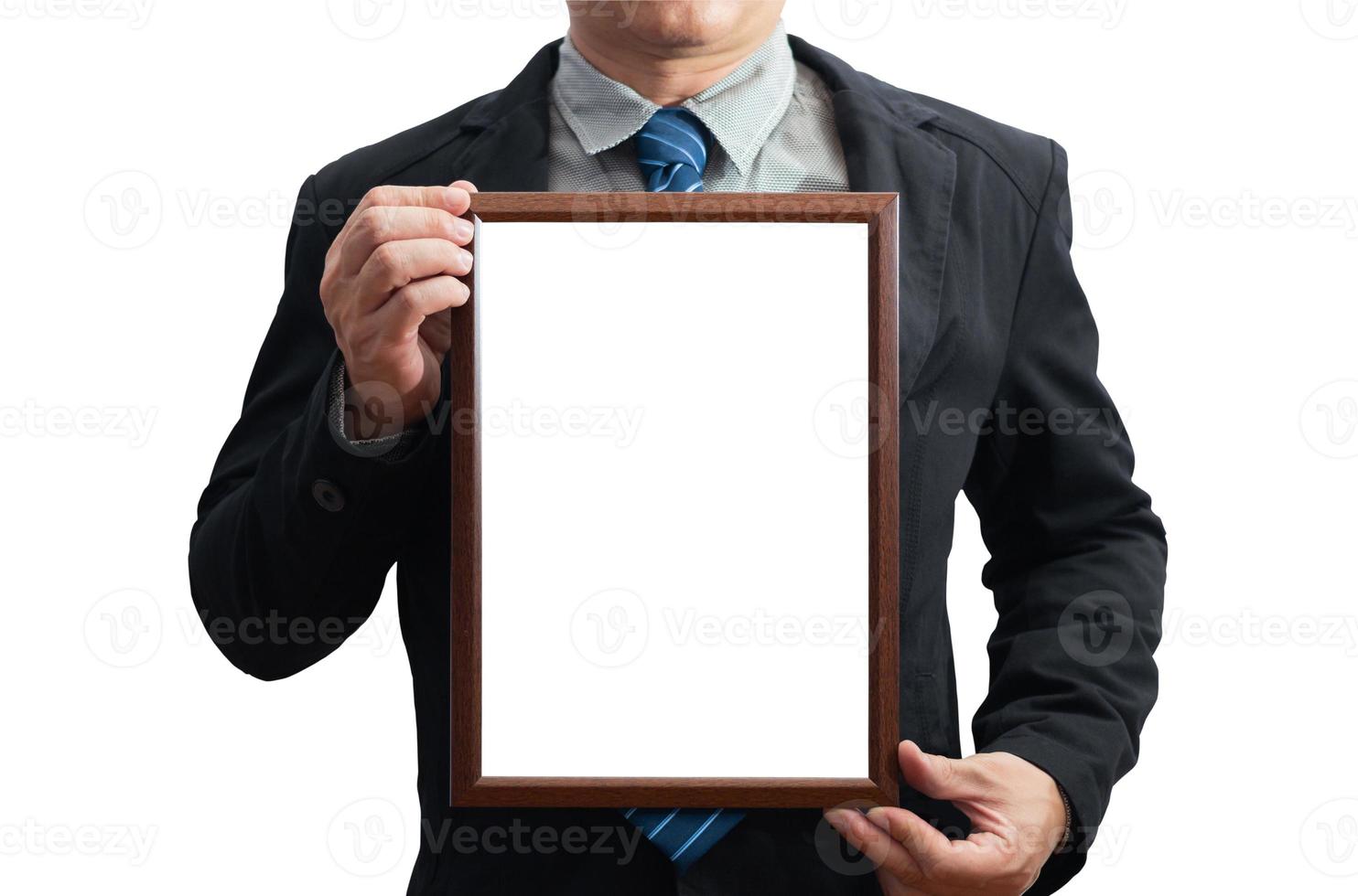 A blank diploma or a mockup certificate in the hand of a male employee wearing a black suit on white background with a clipping path.Picture frame is empty and the copy space.selective focus photo