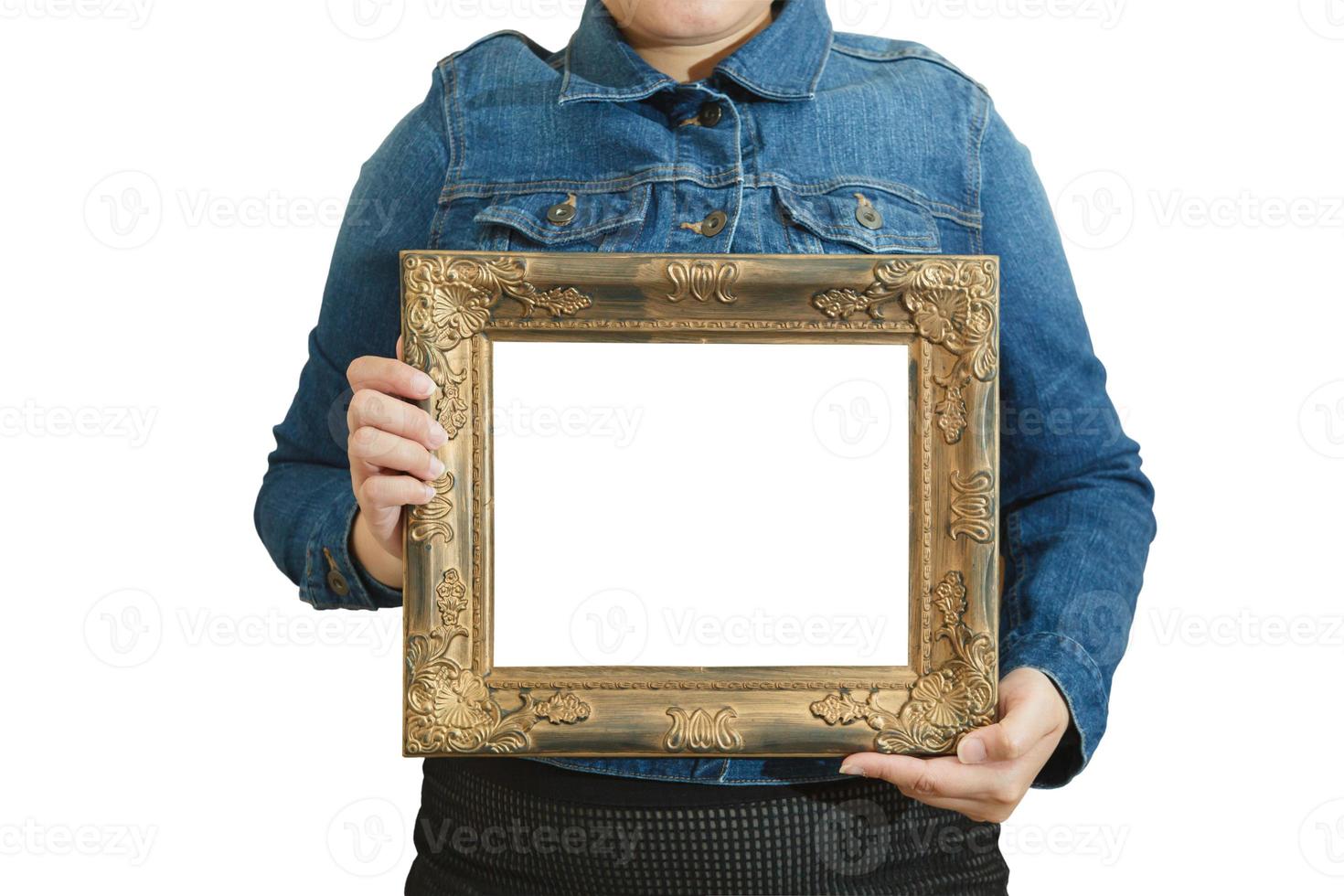 A blank diploma or a mockup certificate in the hand of a woman employee wearing a denim shirt on white background with a clipping path.The horizontal picture frame is empty and the copy space. photo