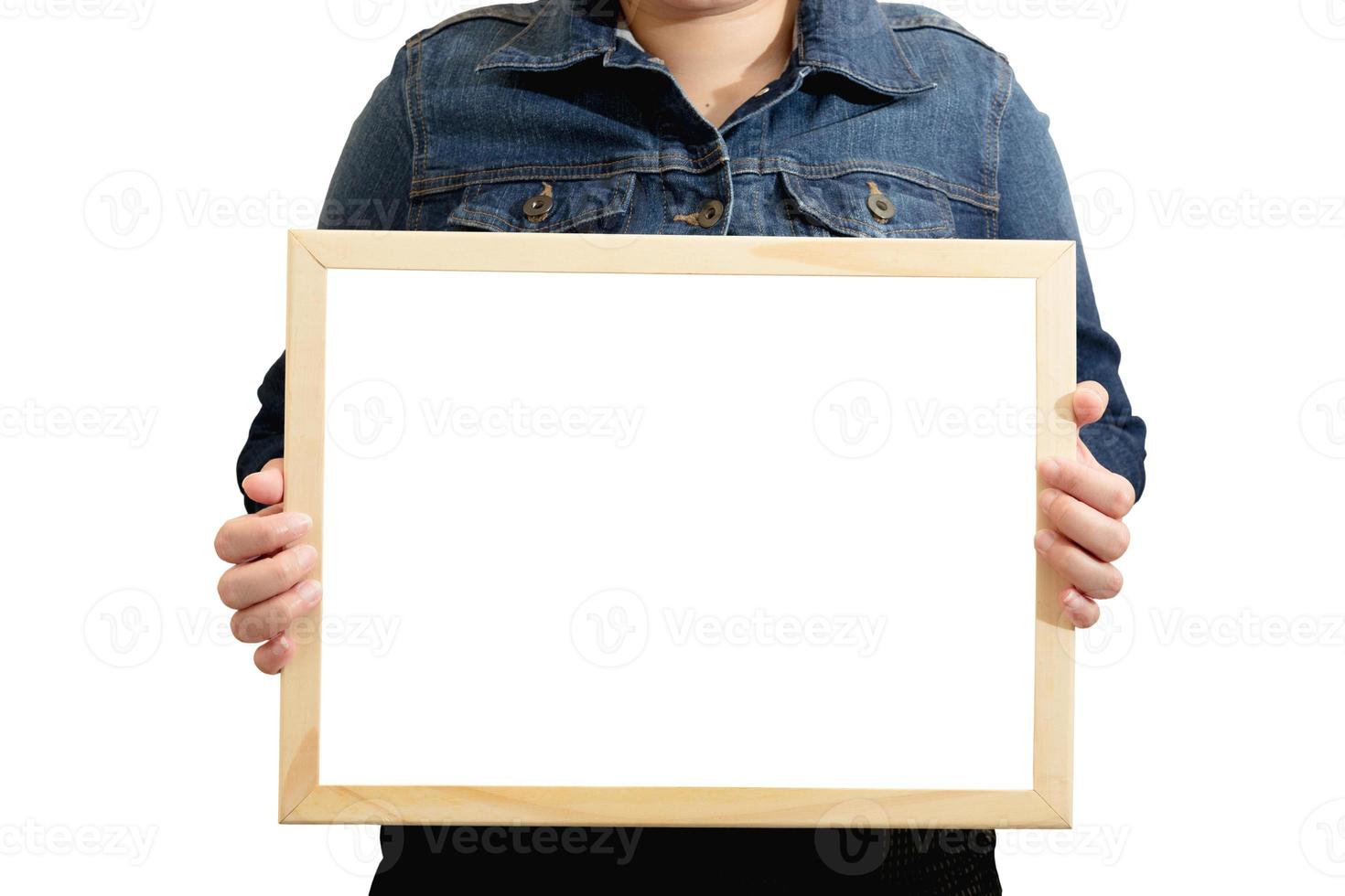 A blank diploma or a mockup certificate in the hand of a woman employee wearing a denim shirt on white background with a clipping path. The horizontal picture frame is empty and the copy space. photo