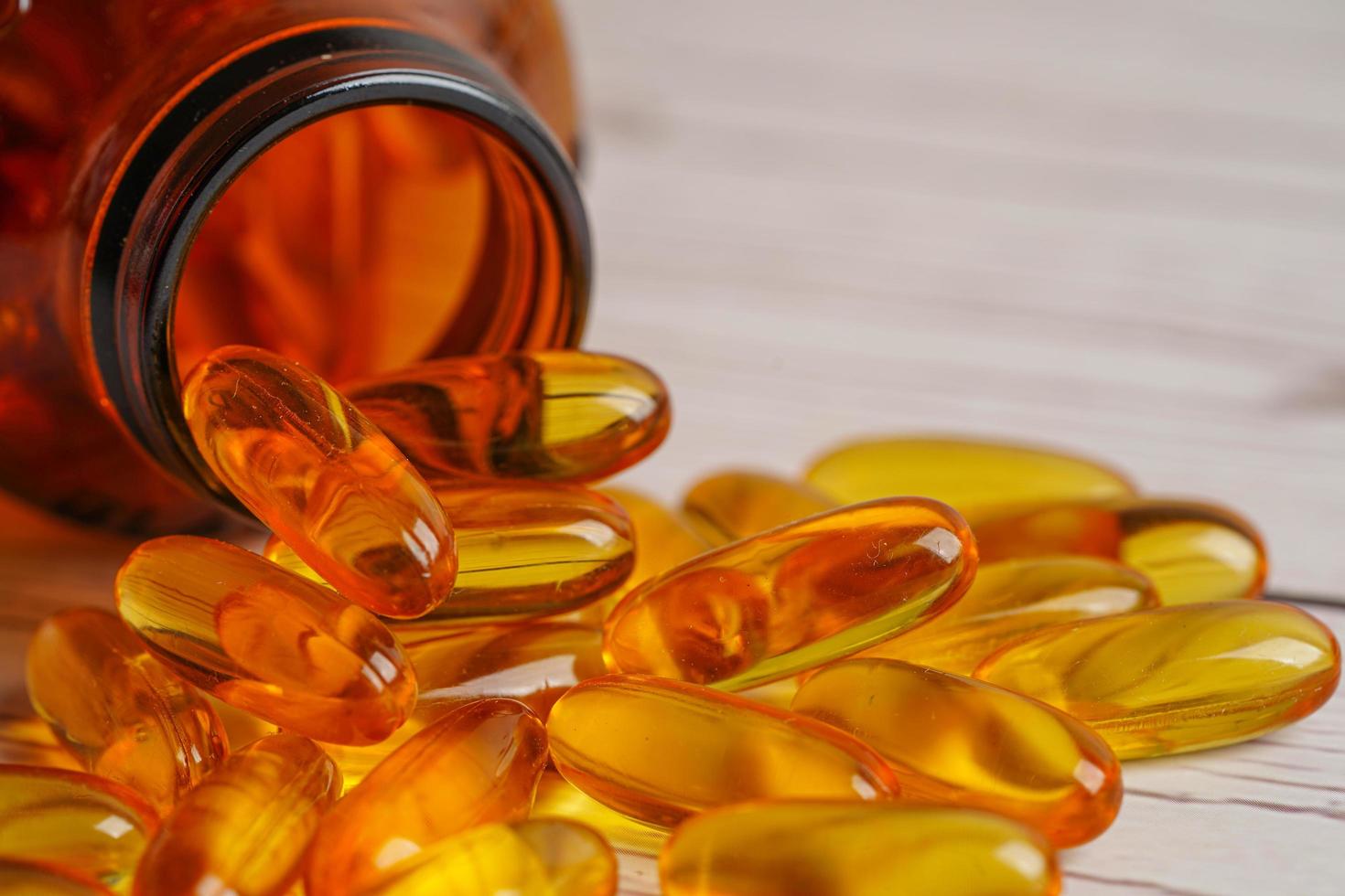 Fish oil or Cod liver oil gel in capsules with omega 3 vitamins, supplementary healthy food photo
