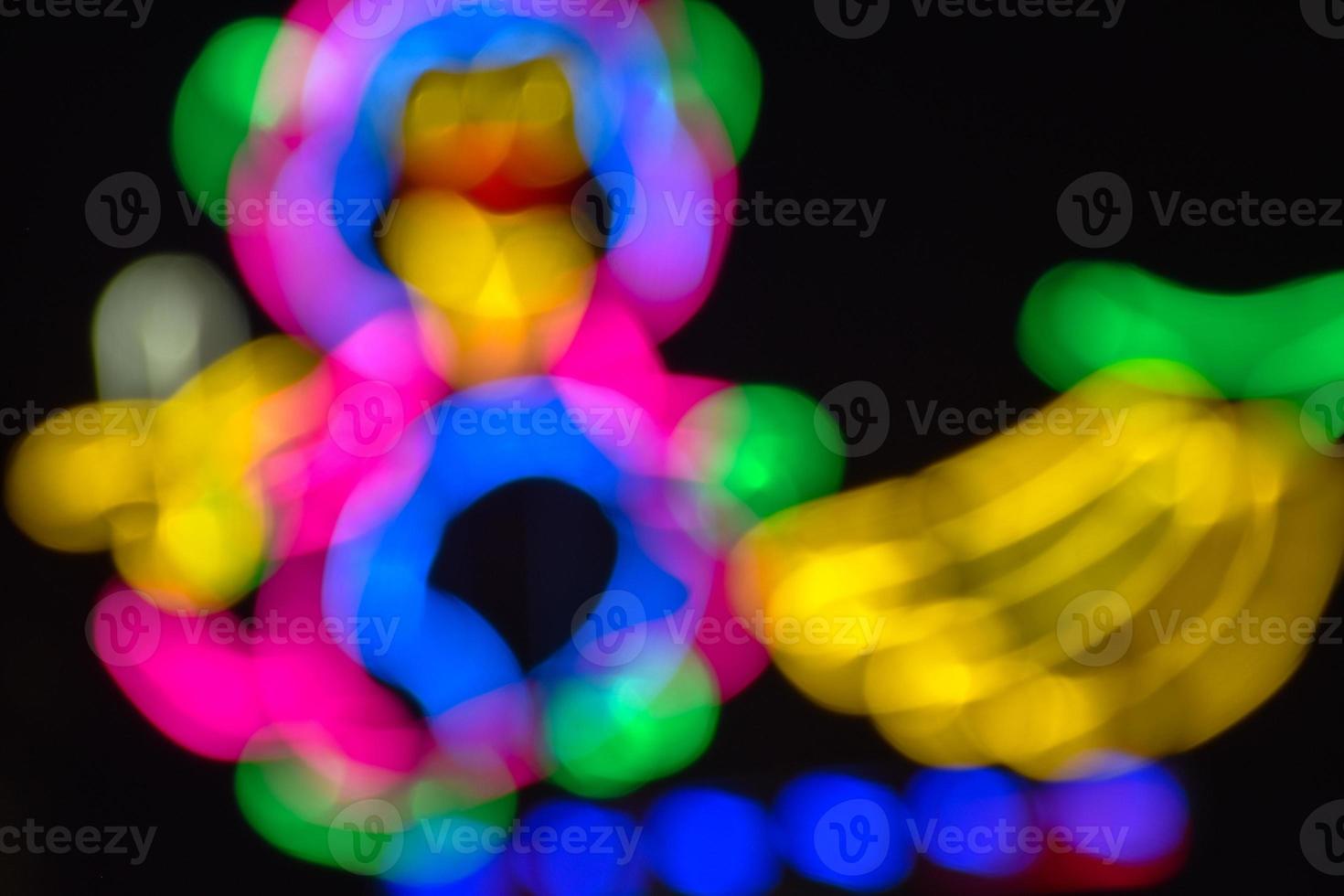 Night lights and bokeh from the amusement park ride photo