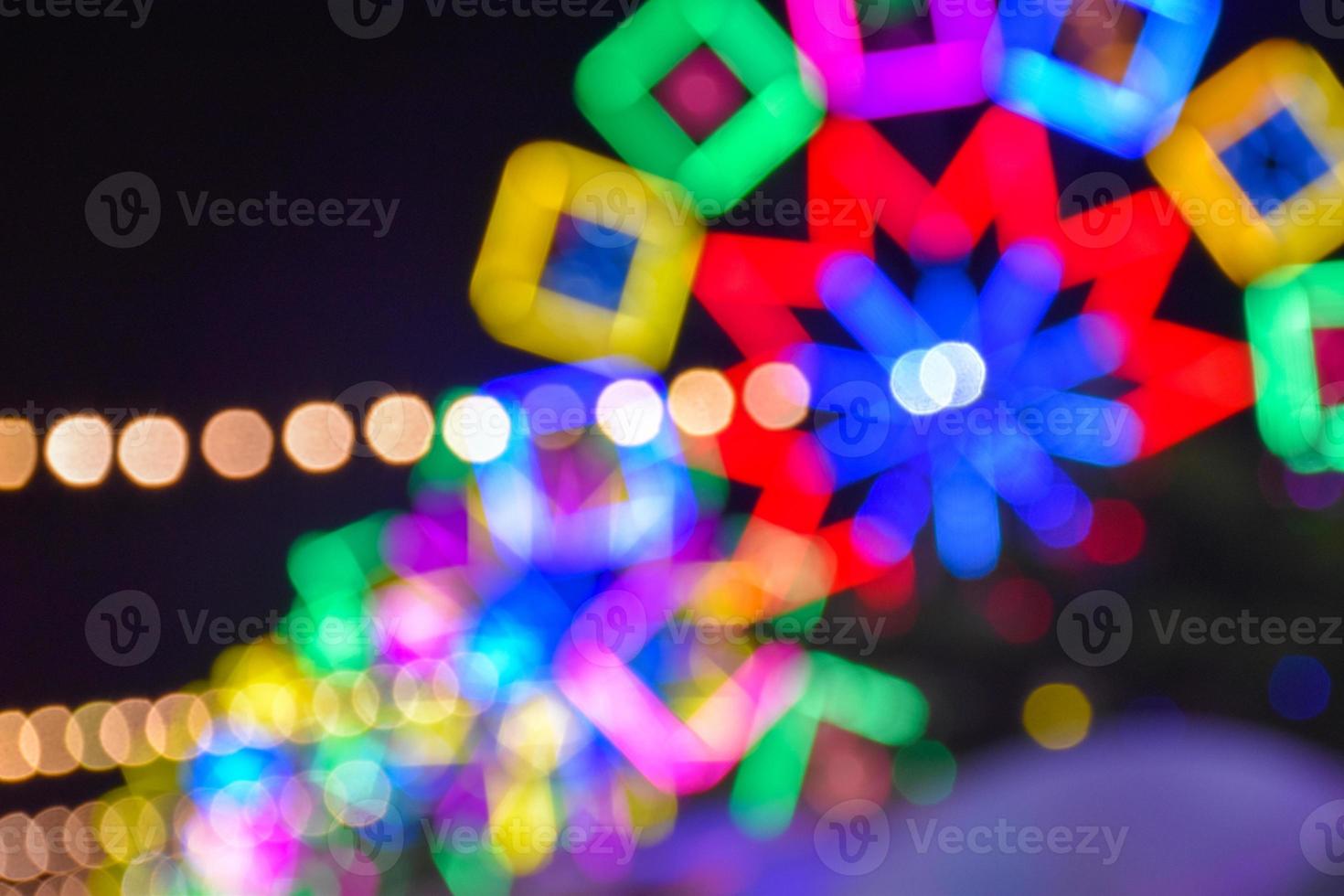 Night lights and bokeh from the amusement park ride photo