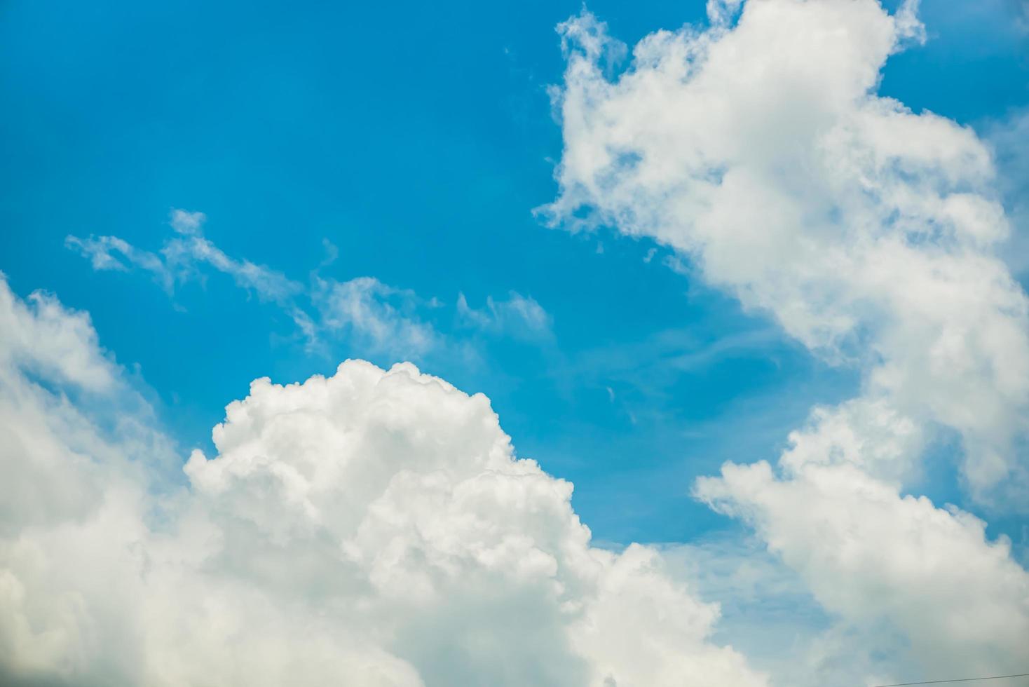 Fantastic soft white clouds against blue sky background photo