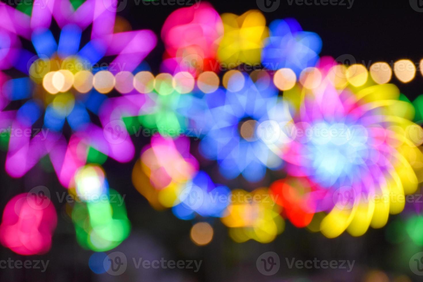 Night lights and bokeh from the amusement park ride photo