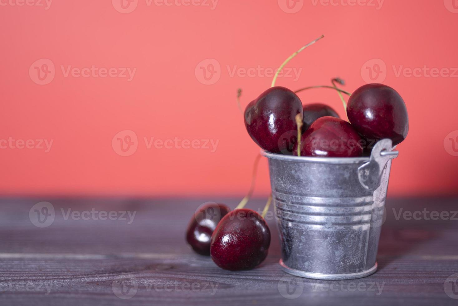 Cherry in a bucket on a dark and red background. 8919103 Stock Photo at
