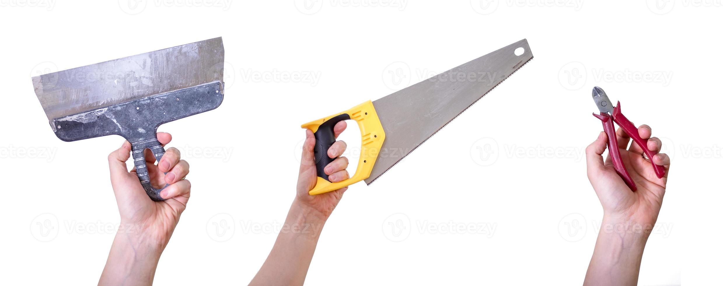 Hands holding hand tools, insulated on white background. photo