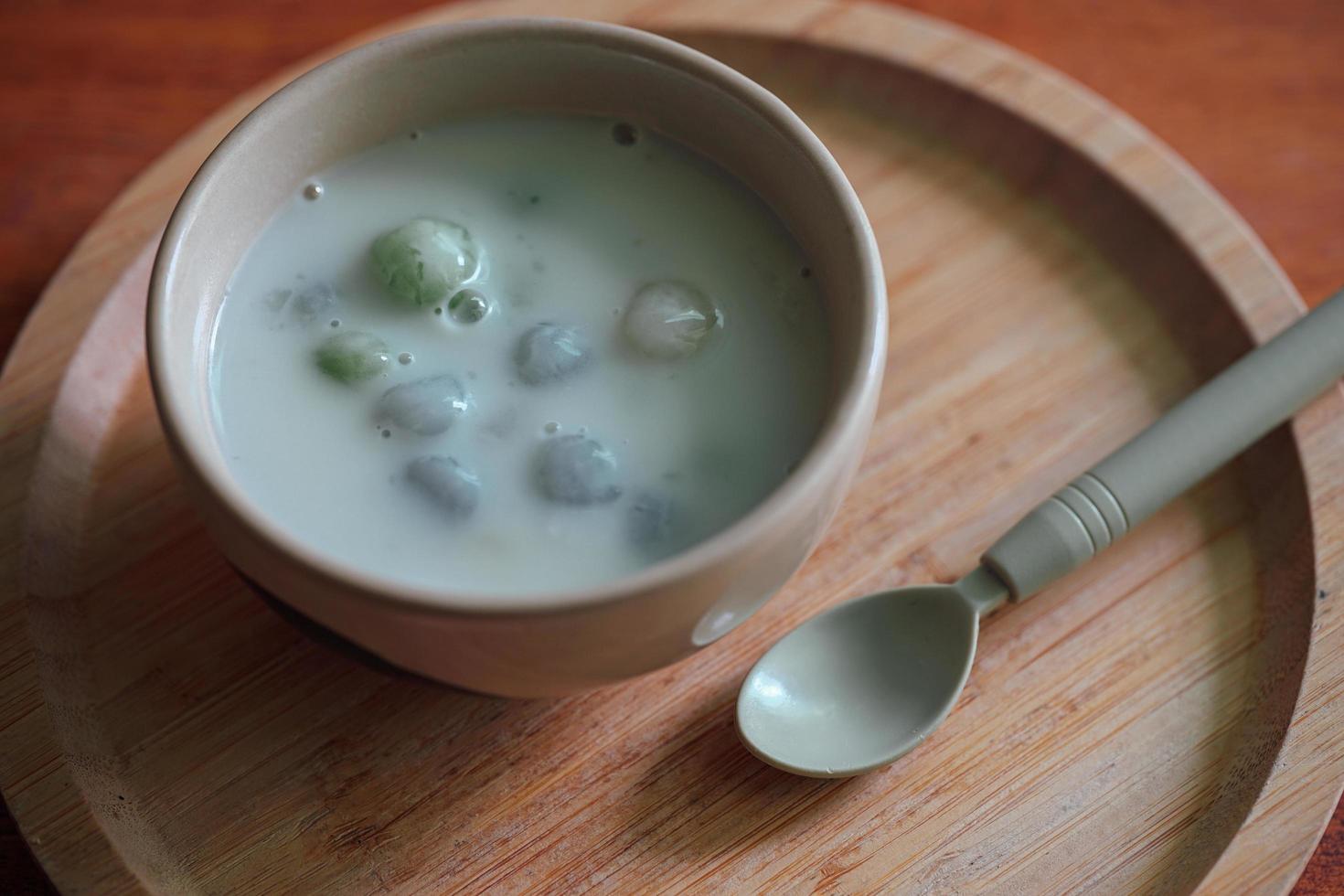 Thai sweetmeat with colorful ball flour. Thai glutinous rice balls in creamy coconut milk syrup. Famous Thai dessert Bualoy photo