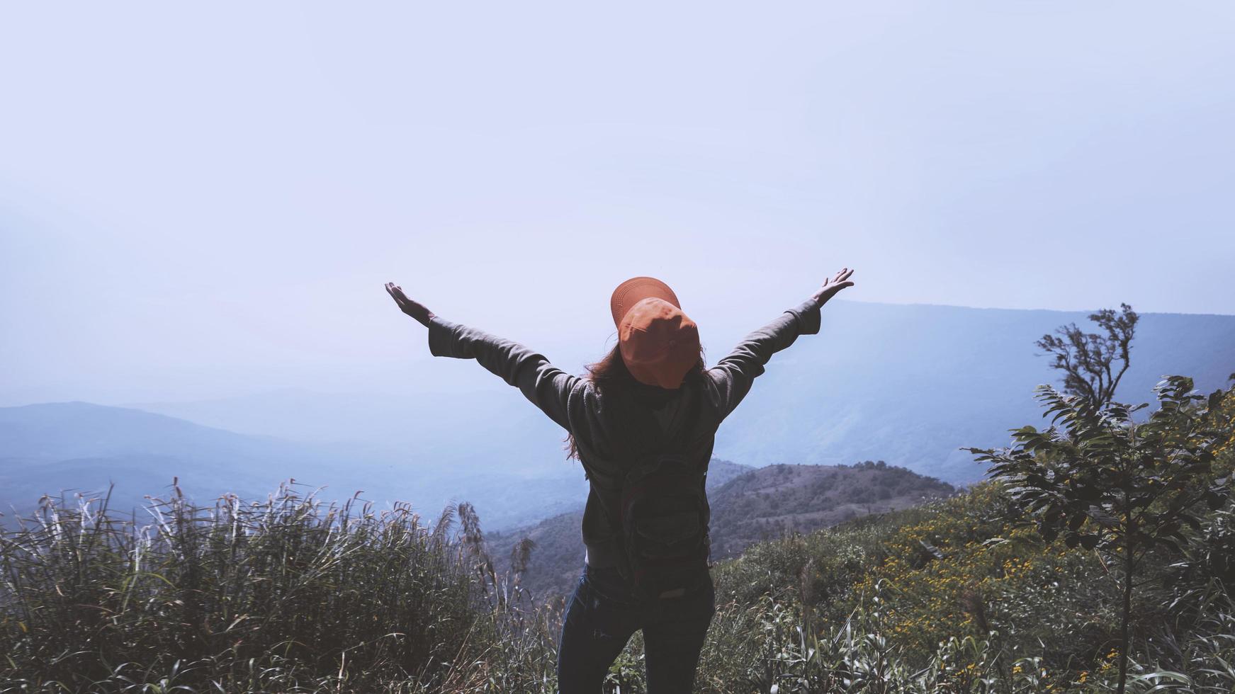 Asian women travel relax in the holiday.  Stand and watch landscape on the Moutain. Mountain Park happily. In Thailand photo