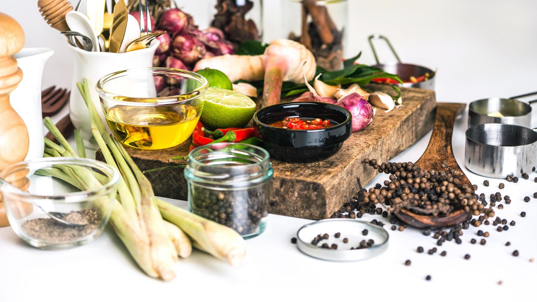 Spices for use as cooking ingredients on a wooden background with Fresh vegetables. Healthy food herbs. Organic vegetables on the table. Raw materials of cooking preparation Tom Yum. photo