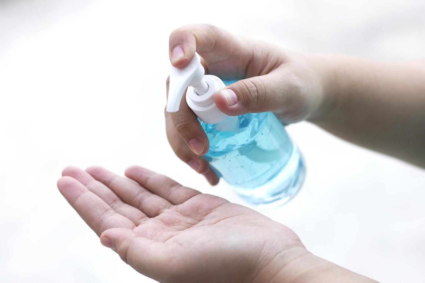 Woman pressing alcohol gel cleaning bacteria and virus on white background. photo
