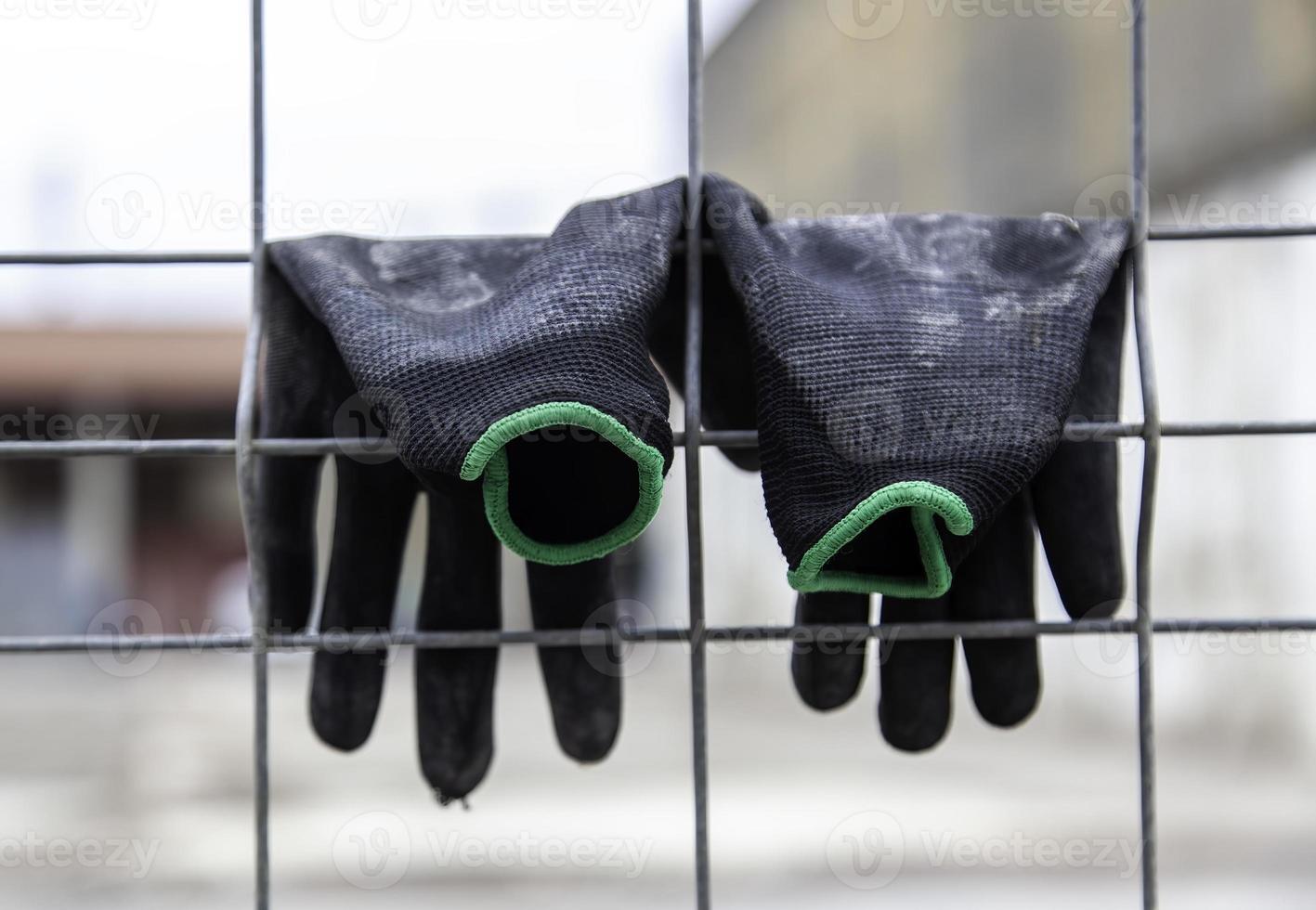 Gloves hanging on a fence photo