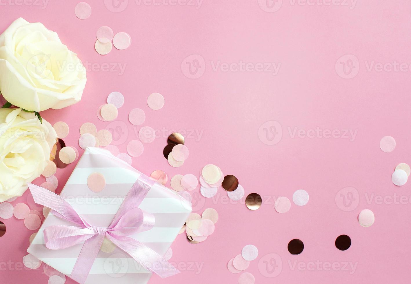 gift boxes and rose flowers on pink background. Happy Valentines day, Mothers day, birthday concept. Romantic flat lay composition. photo