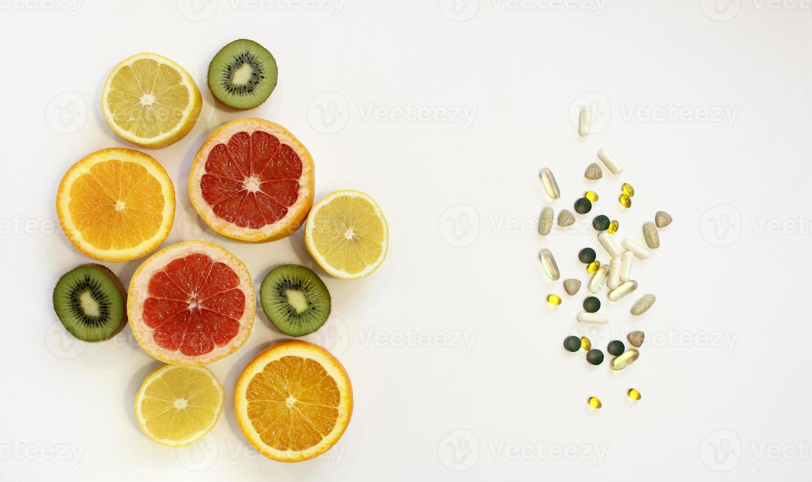 fresh natural fruits vs pills. Natural vitamin in fruits vs synthetic vitamin in pills. Choice between natural and synthetic way of health care. Alternative medicine. photo