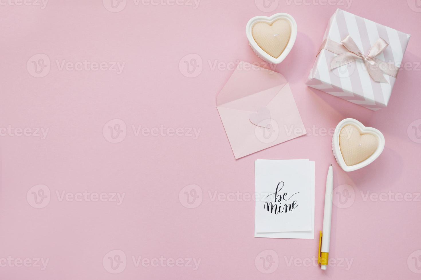 Happy Valentines Day composition. Blank greeting card mockup, gift boxes, hearts, confetti on pink background photo