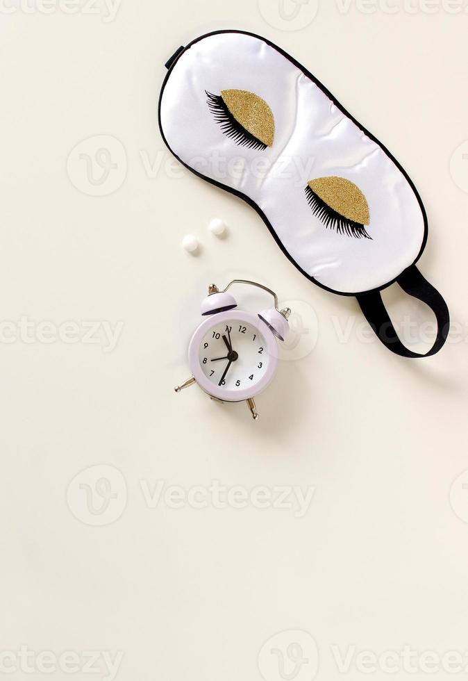 Flat lay composition with sleep eye mask, dream book and alarm clock on background. Healthy sleeping concept. photo