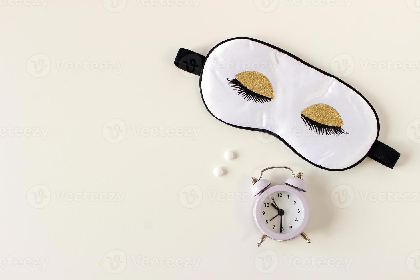 Flat lay composition with sleep eye mask, dream book and alarm clock on background. Healthy sleeping concept. photo