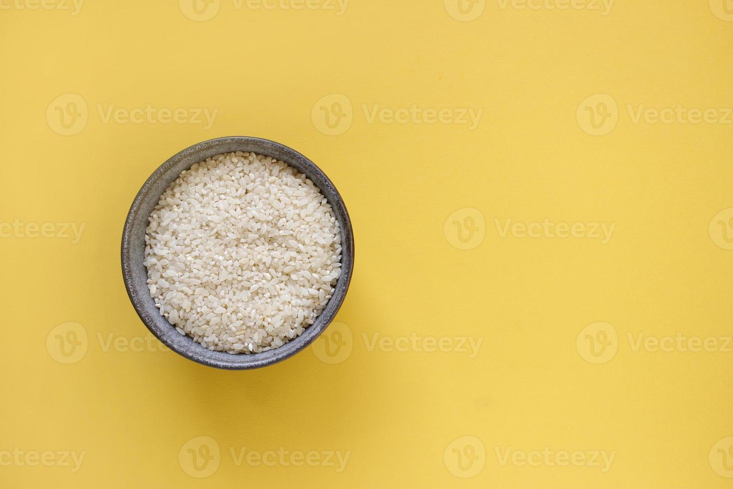 grey bowl with rice on background with copy space for your text, top view. Natural food high in protein photo
