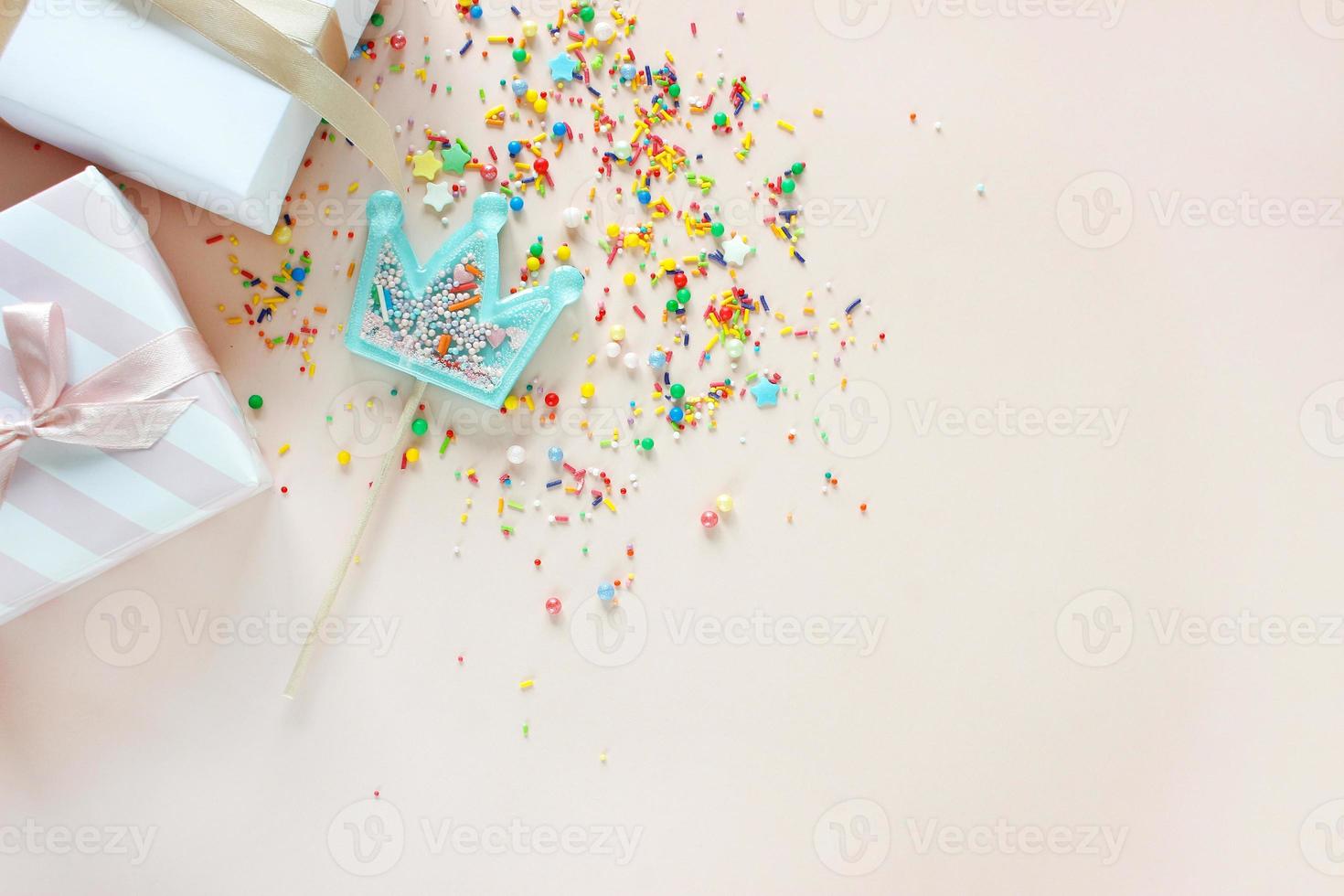 Birthday party background with gift and lollipops. Copy space. photo