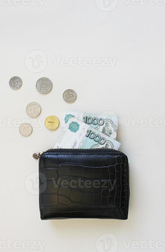 Russian rubles in the wallet on background. Thousand notes and various coins. Place for text. Copy space. background for economic news. photo