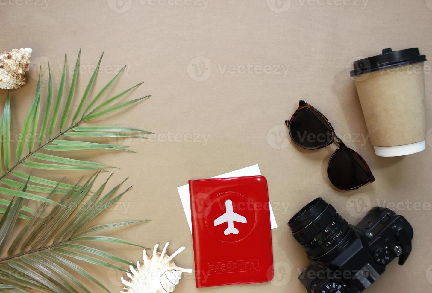 Traveler accessories, tropical palm leaf branches on background with empty space for text. Travel vacation concept. Summer background. Road frame set. Flat lay, top view. photo