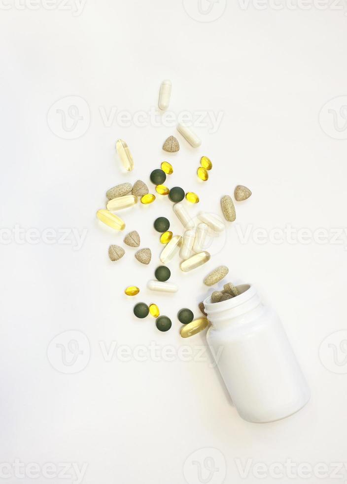 Vitamin tablets. Bottle with colored pills on background. Multivitamins. photo