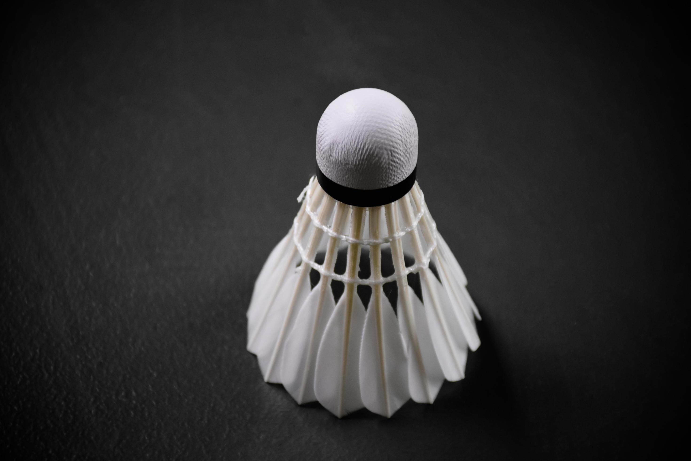 Badminton sports equipments, shuttlecocks, racket, grip, on floor of