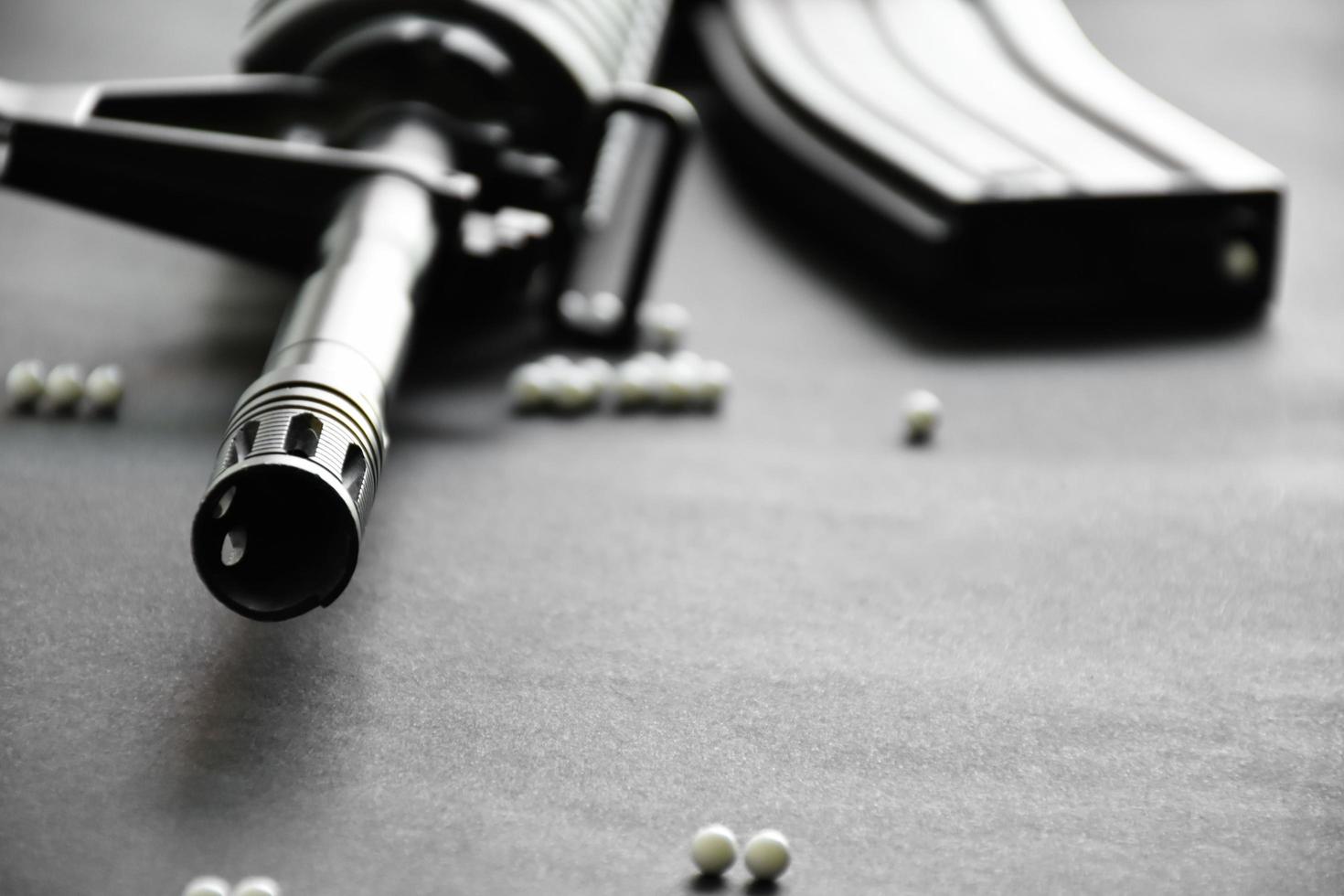 Closeup of white plastic bullets of airsoft gun or bb gun on wooden floor, soft and selective focus on white bullets. photo