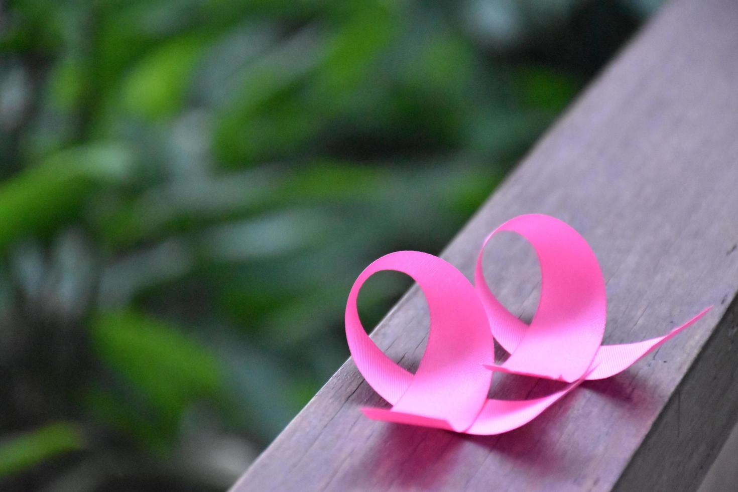 The pink ribbon in hand, a symbol of the global women's breast cancer campaign. photo