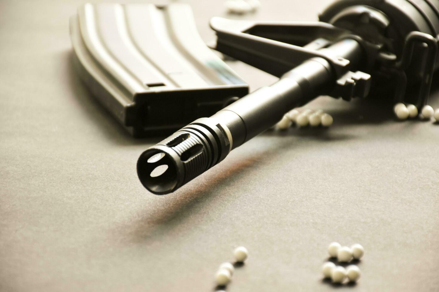 Closeup of white plastic bullets of airsoft gun or bb gun on wooden floor, soft and selective focus on white bullets. photo